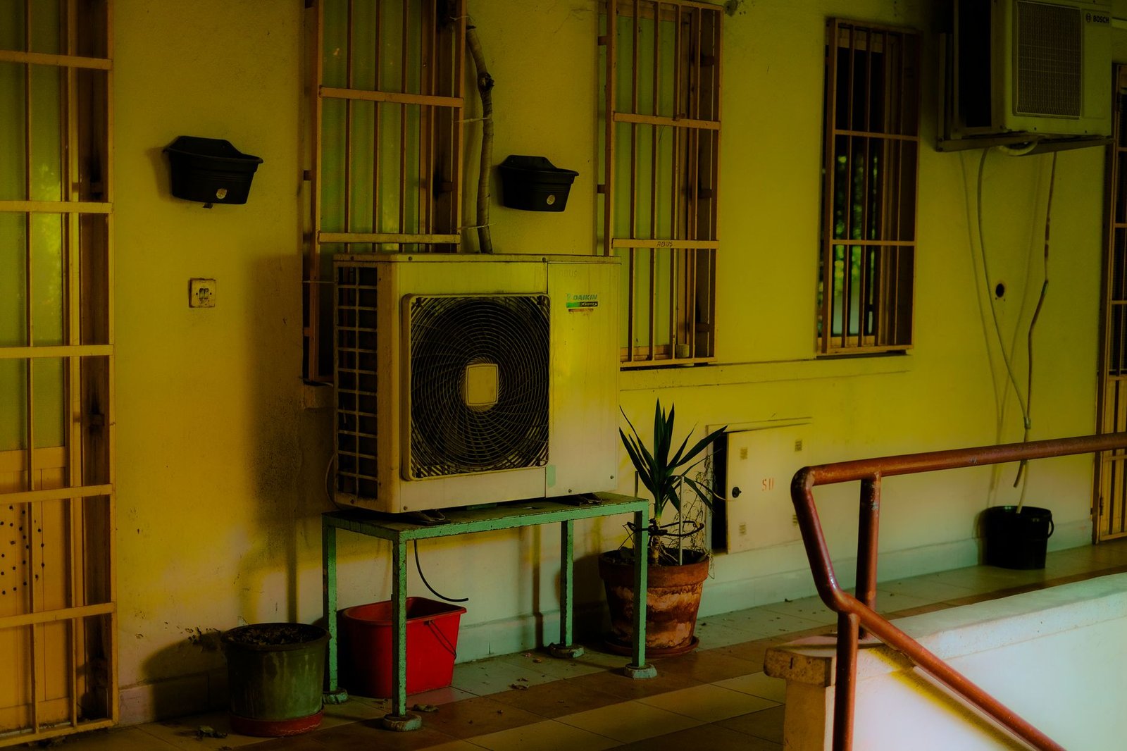 Outdoor condenser unit beside a residential building